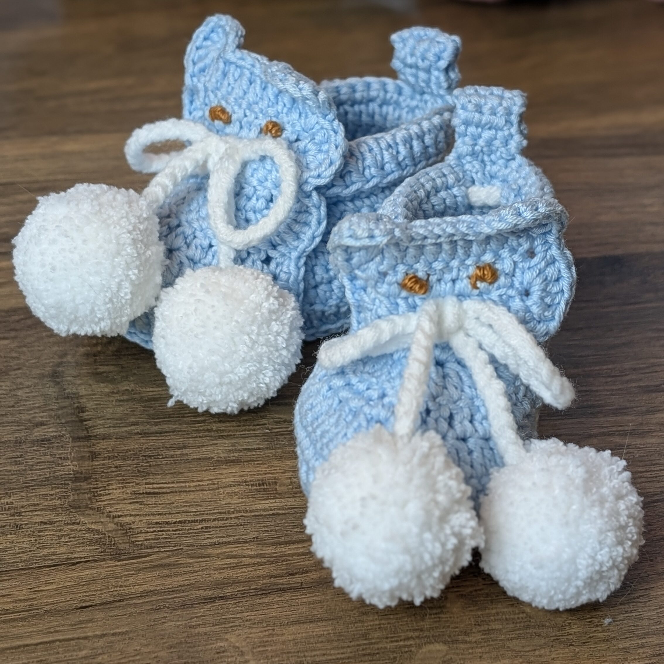 Crochet baby booties styled with Christmas gift wrapping ideas